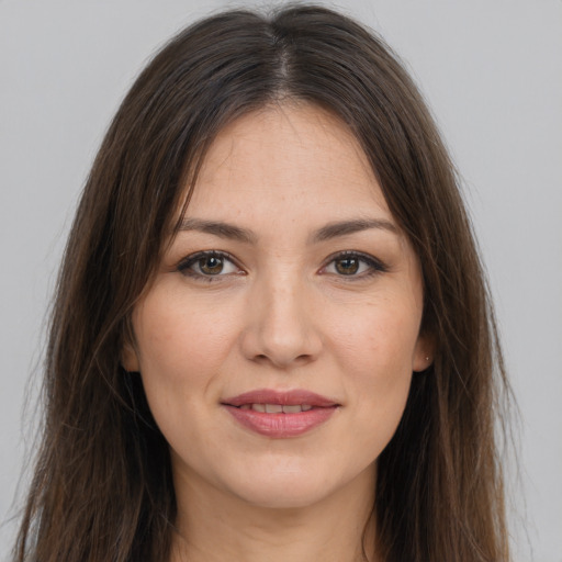 Joyful white young-adult female with long  brown hair and brown eyes