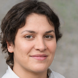 Joyful white adult female with medium  brown hair and brown eyes