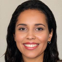 Joyful latino young-adult female with long  black hair and brown eyes