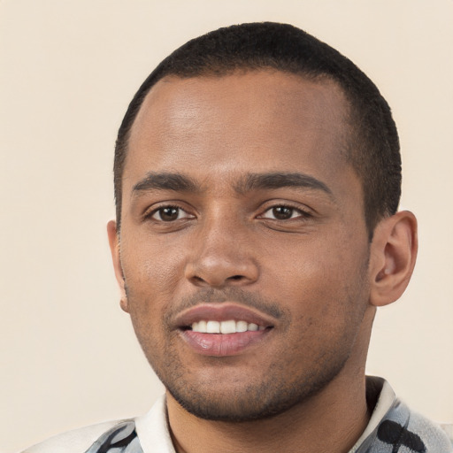 Joyful black young-adult male with short  black hair and brown eyes