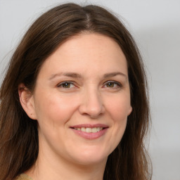 Joyful white young-adult female with medium  brown hair and blue eyes