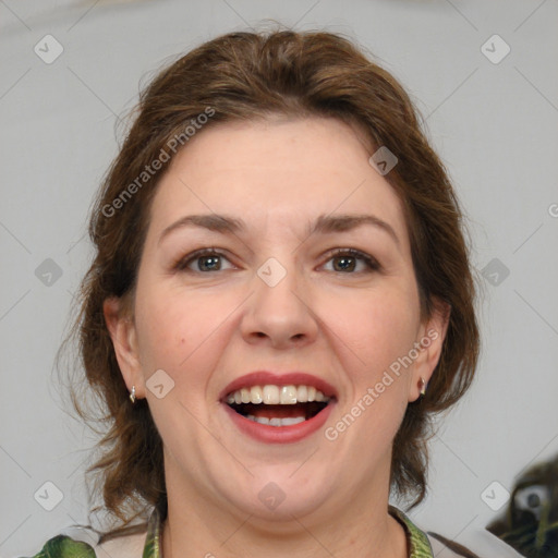 Joyful white adult female with medium  brown hair and green eyes