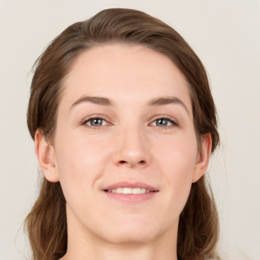 Joyful white young-adult female with medium  brown hair and grey eyes