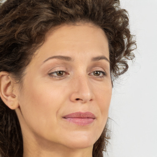 Joyful white adult female with long  brown hair and brown eyes