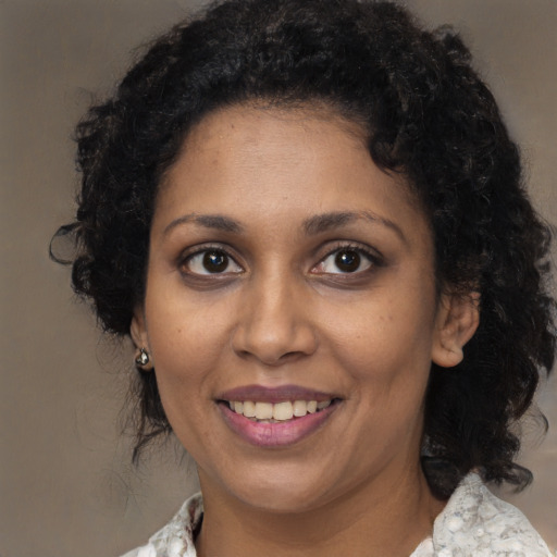 Joyful black young-adult female with medium  black hair and brown eyes