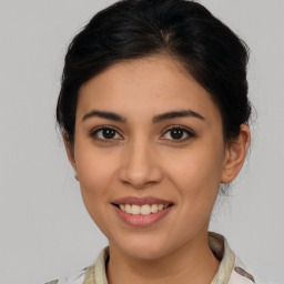 Joyful latino young-adult female with medium  brown hair and brown eyes