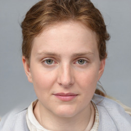 Joyful white young-adult female with medium  brown hair and blue eyes