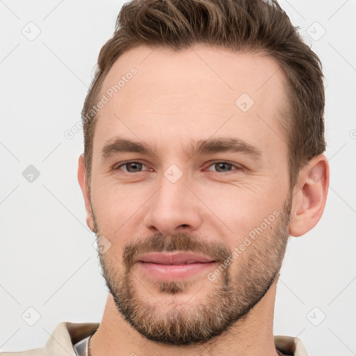 Joyful white young-adult male with short  brown hair and brown eyes