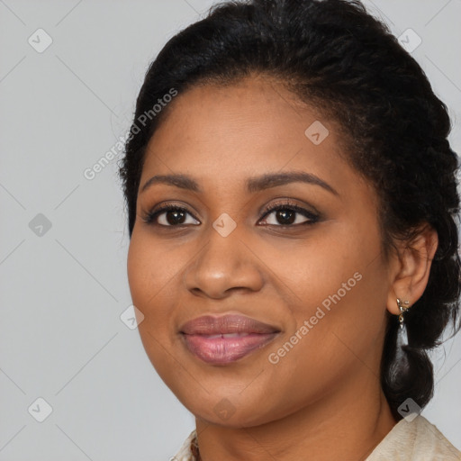 Joyful black young-adult female with long  black hair and brown eyes