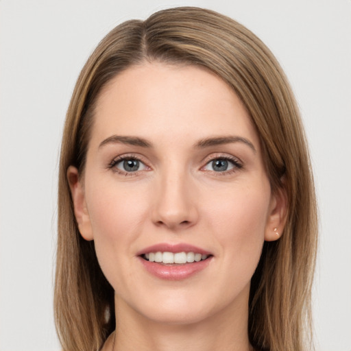 Joyful white young-adult female with long  brown hair and grey eyes