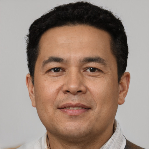 Joyful white adult male with short  black hair and brown eyes