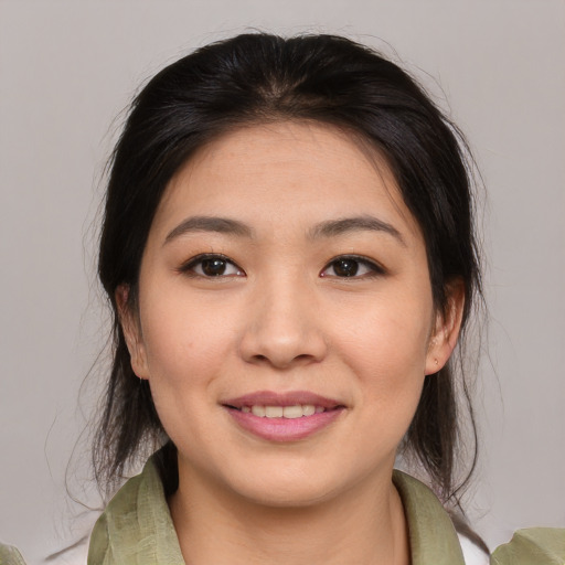 Joyful asian young-adult female with medium  brown hair and brown eyes
