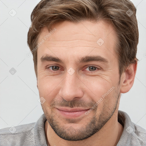 Joyful white adult male with short  brown hair and grey eyes