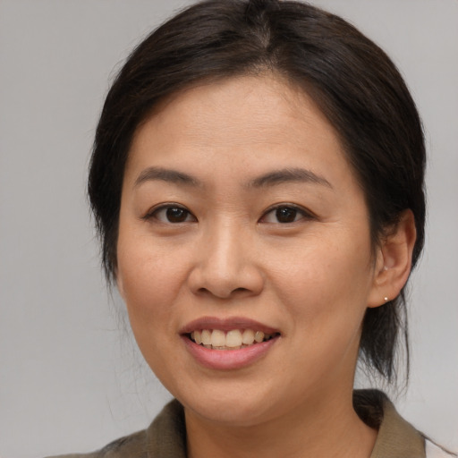 Joyful asian young-adult female with medium  brown hair and brown eyes