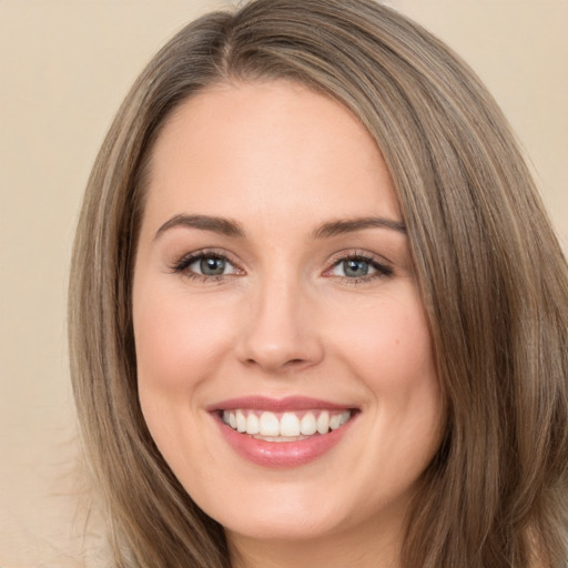 Joyful white young-adult female with long  brown hair and brown eyes