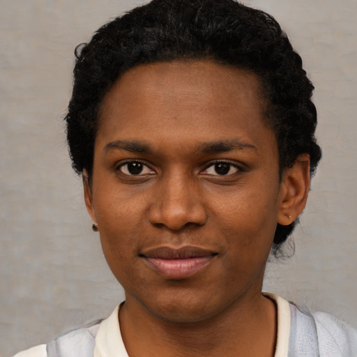 Joyful black young-adult female with short  black hair and brown eyes