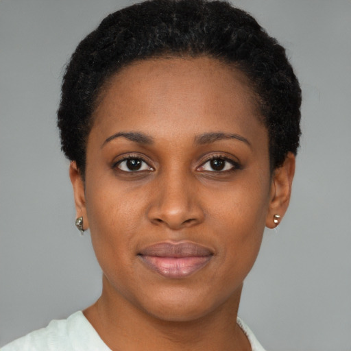 Joyful black young-adult female with short  brown hair and brown eyes