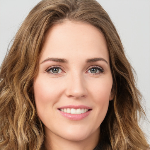 Joyful white young-adult female with long  brown hair and green eyes