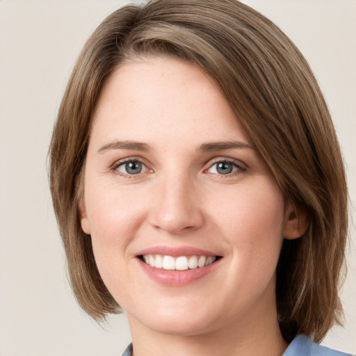 Joyful white young-adult female with medium  brown hair and green eyes