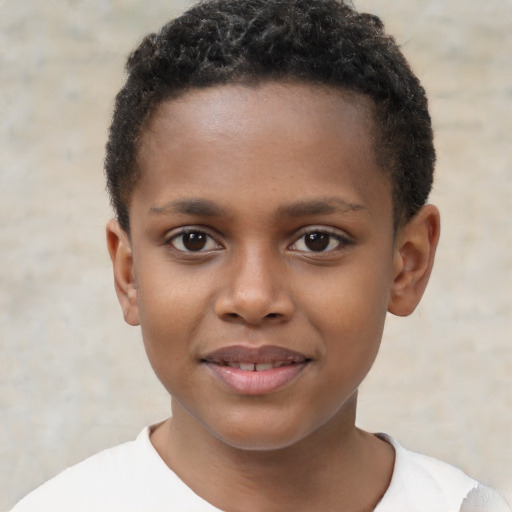 Joyful black child male with short  brown hair and brown eyes