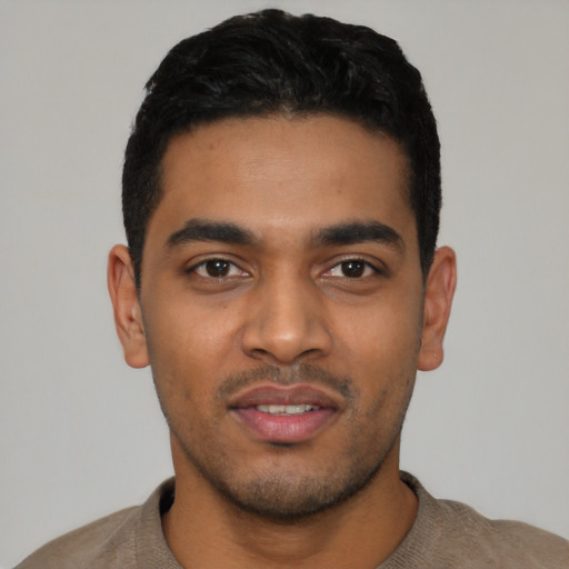 Joyful latino young-adult male with short  black hair and brown eyes