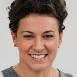 Joyful white young-adult female with short  brown hair and brown eyes