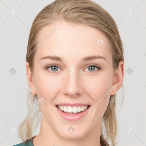 Joyful white young-adult female with long  brown hair and blue eyes