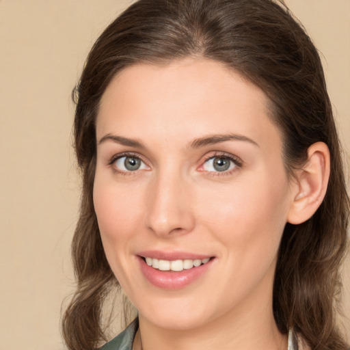 Joyful white young-adult female with long  brown hair and brown eyes