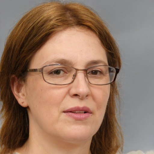 Joyful white adult female with medium  brown hair and brown eyes