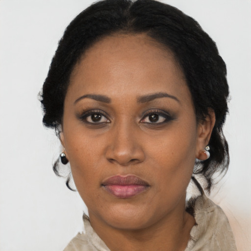 Joyful black adult female with medium  black hair and brown eyes