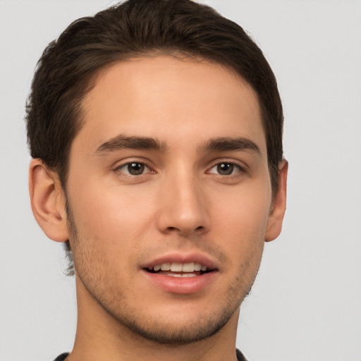 Joyful white young-adult male with short  brown hair and brown eyes