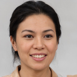 Joyful asian young-adult female with medium  brown hair and brown eyes