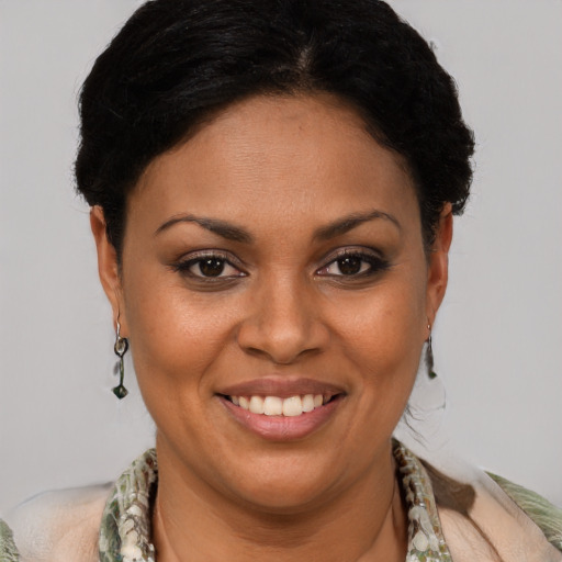 Joyful latino young-adult female with short  brown hair and brown eyes