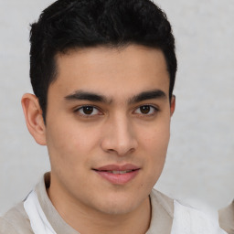 Joyful latino young-adult male with short  brown hair and brown eyes