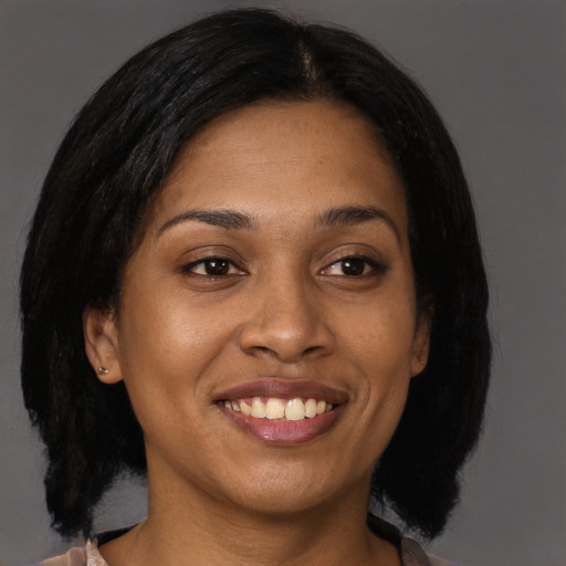 Joyful black young-adult female with medium  brown hair and brown eyes