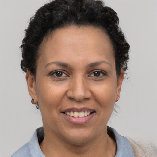 Joyful latino adult female with short  brown hair and brown eyes