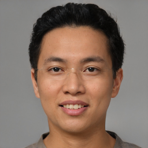 Joyful asian young-adult male with short  black hair and brown eyes