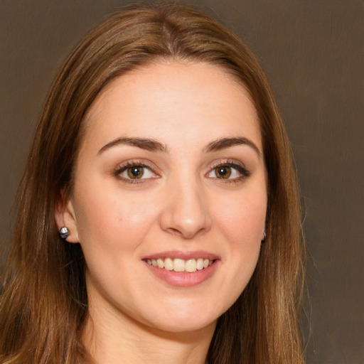 Joyful white young-adult female with long  brown hair and brown eyes