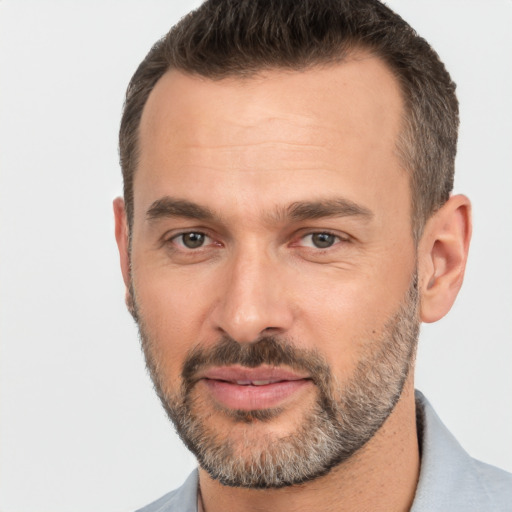 Joyful white adult male with short  brown hair and brown eyes