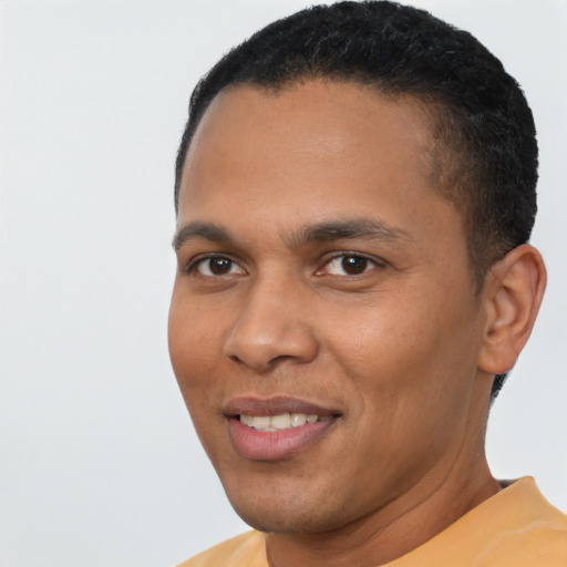 Joyful latino young-adult male with short  brown hair and brown eyes