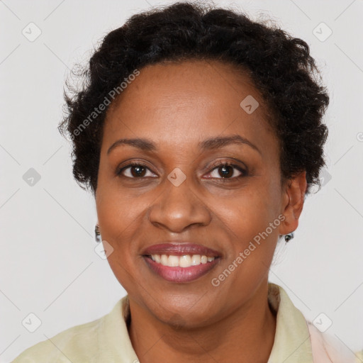 Joyful black adult female with short  brown hair and brown eyes