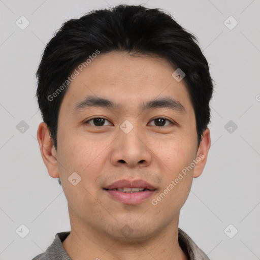 Joyful asian young-adult male with short  black hair and brown eyes