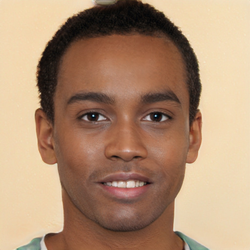 Joyful black young-adult male with short  brown hair and brown eyes