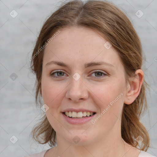 Joyful white young-adult female with medium  brown hair and blue eyes