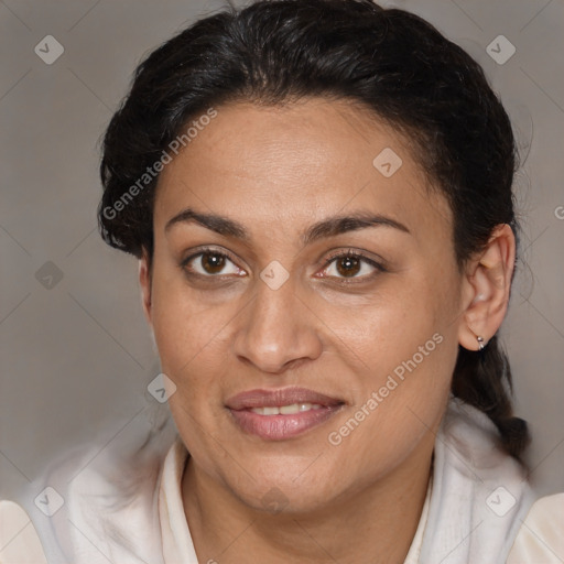 Joyful latino adult female with medium  brown hair and brown eyes