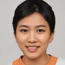 Joyful asian young-adult female with short  black hair and brown eyes