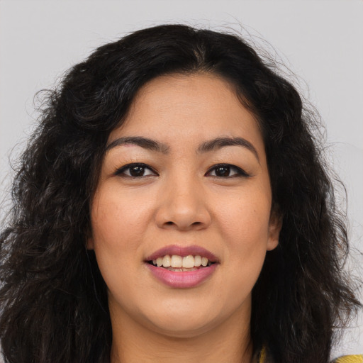 Joyful white young-adult female with long  black hair and brown eyes