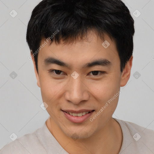 Joyful asian young-adult male with short  brown hair and brown eyes