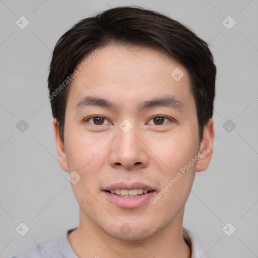 Joyful asian young-adult male with short  brown hair and brown eyes