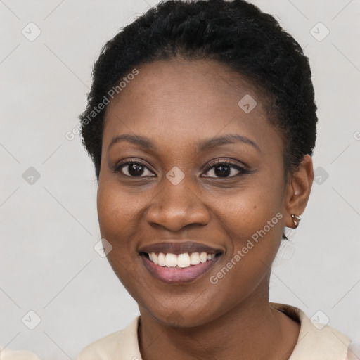 Joyful black young-adult female with short  brown hair and brown eyes